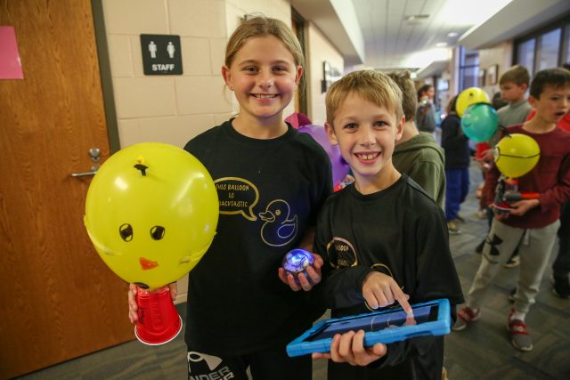 students with balloon float