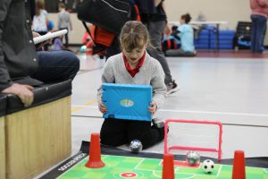 Student with laptop operating Sphero bot