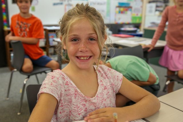 smiling, young female student in classroom 