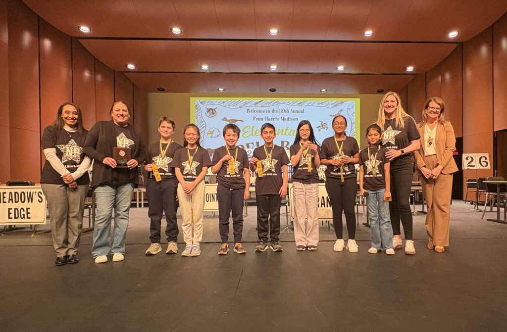 A group of people standing on a stage in front of a podium, receiving awards for their achievements.