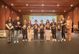 A group of people standing on a stage in front of a podium, receiving awards for their achievements.
