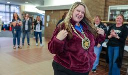 Principal Lorraine White gives Miss Taylor the MVP chain necklace for the brag walk