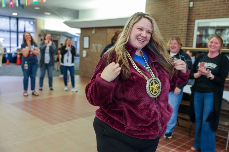 Principal Lorraine White gives Miss Taylor the MVP chain necklace for the brag walk