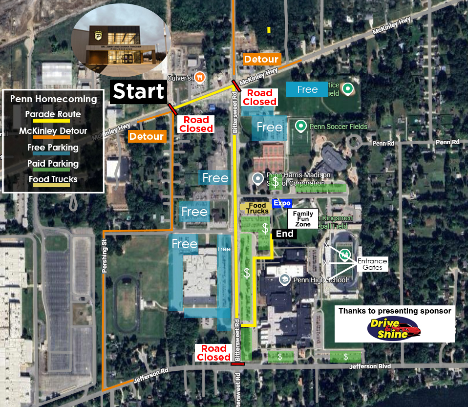 Aerial view of a city street, showing a start/finish line, a road closed sign, and various businesses and landmarks.